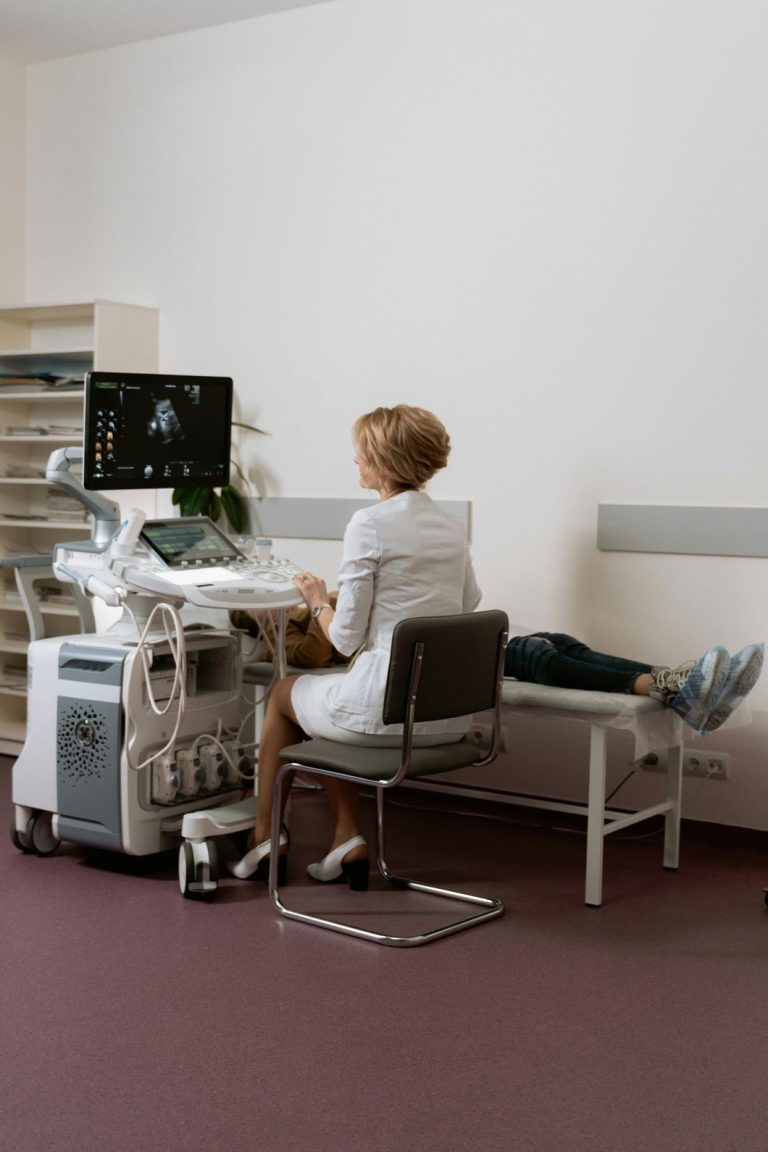 Skilled technician conducting a walk-in ultrasound at a Houston clinic, using modern equipment on a patient.
