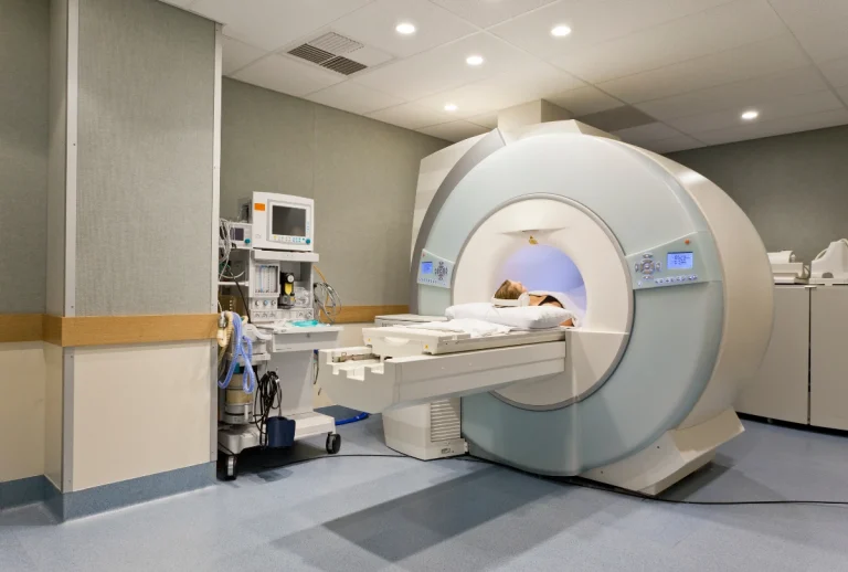 Patient resting inside advanced MRI machine for low-dose CT scans Houston, supported by cutting-edge equipment in a professional medical setting.