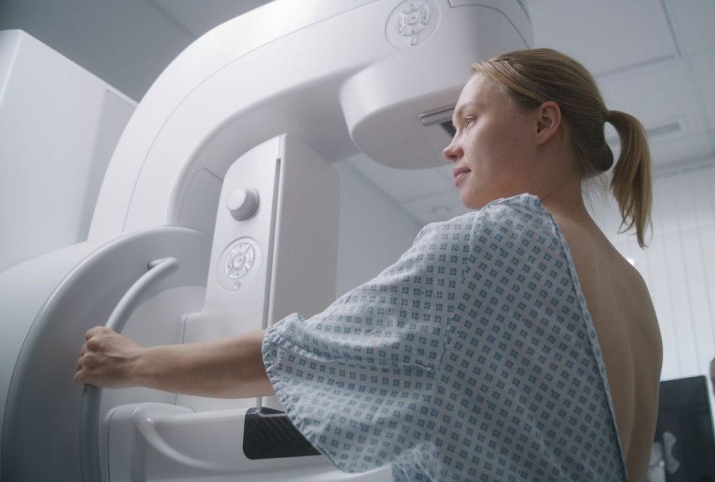 Patient undergoing 3D mammogram in Houston clinic, highlighting advanced breast cancer screening technology and care.