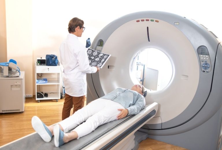Houston technician reviews brain images during cheap CT scan procedure for accurate medical diagnosis and care.