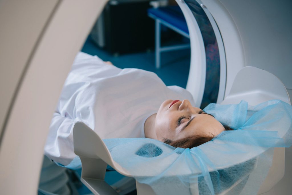 Patient lying comfortably in an MRI scanner during a brain scan procedure, experiencing precise diagnostics at top MRI Houston facility.
