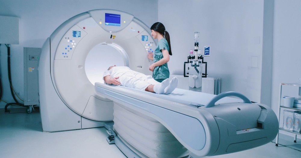 Radiology technician prepares a patient for cheap CT scans using advanced imaging technology in a Houston clinic.