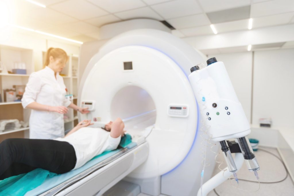 An expert technologist operates the scanner while a patient lies comfortably, a key part of our mri services houston.