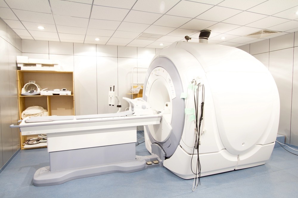 An open, modern MRI scanner is ready in a clean, professional clinical suite, ideal for non-invasive mri services houston.