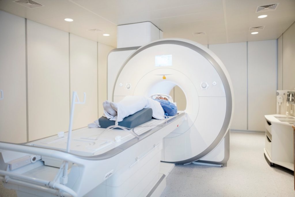 A patient prepares for a scan inside a state-of-the-art machine, highlighting professional mri services houston.