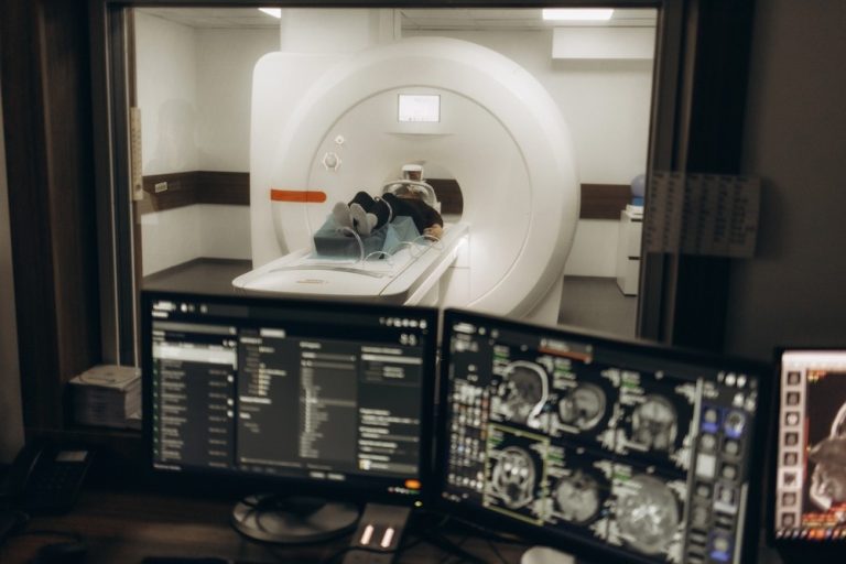 Expert Houston radiologists review multi-view brain images on dual screens, for detailed diagnostic mri services houston.