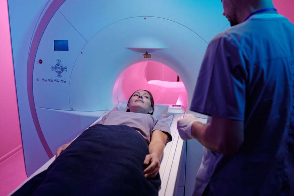 Patient lies inside the large, circular opening of an advanced MRI Houston scanner for a precise imaging test.