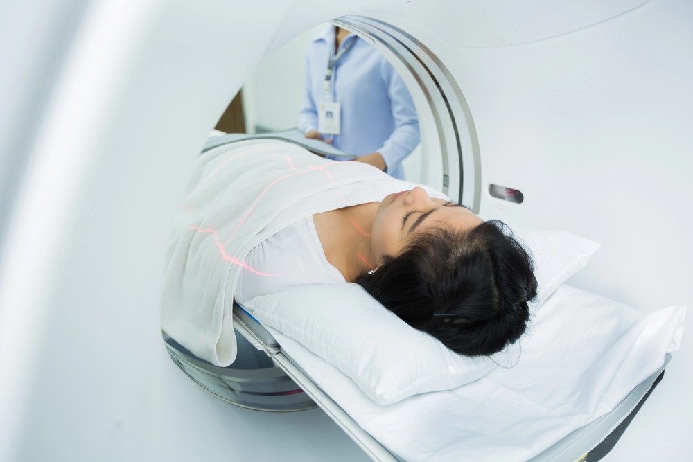 A medical technician aligning laser guides for a patient undergoing a fast scan at a walk-in MRI Houston facility. 