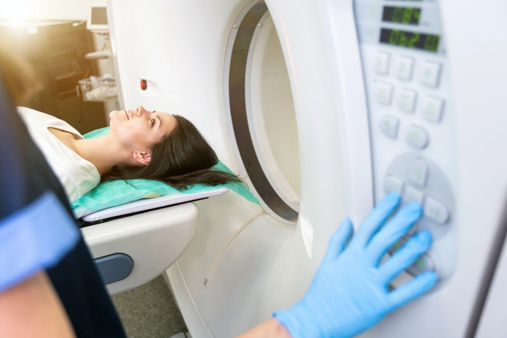 Healthcare provider setting up advanced imaging equipment for a patient at a modern walk-in MRI Houston location. 