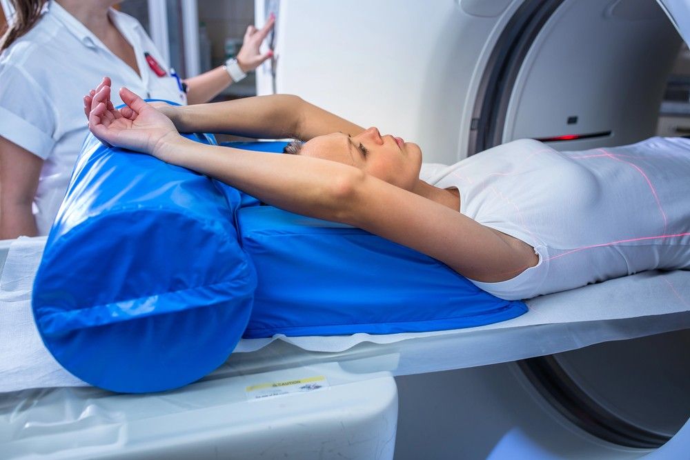 Technician accurately positioning a female patient for a procedure, illustrative of the patient care experience for mri scans houston.