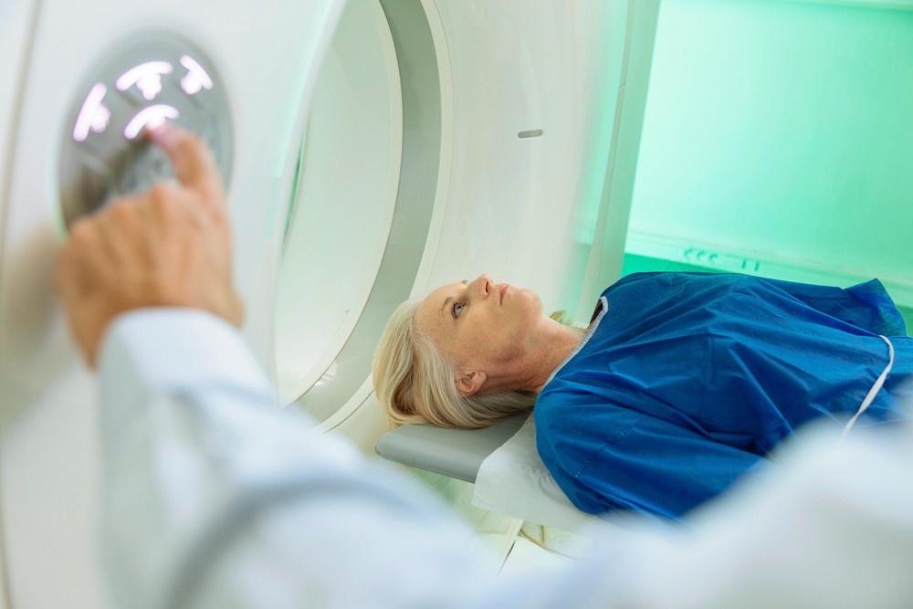 Woman lying on the patient table preparing for diagnostic imaging, representing available mri scans houston services.